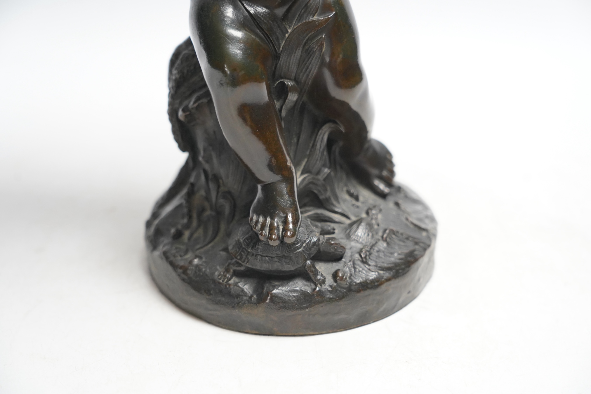 A 19th century bronze figure or centrepiece in the form of putti holding a shell, 34cm